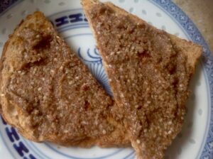 A slice of toast spread with honey smoked walnut butter