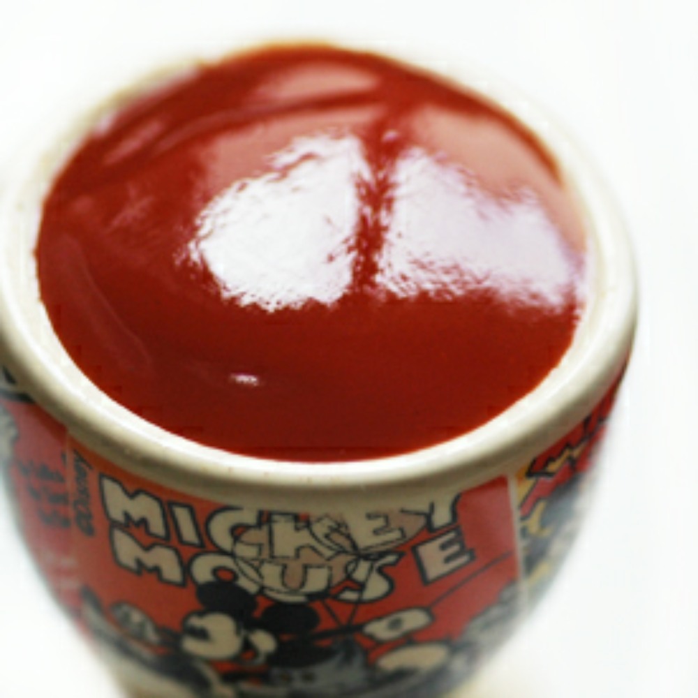 Tomato relish in a small pot with Mickey Mouse on it