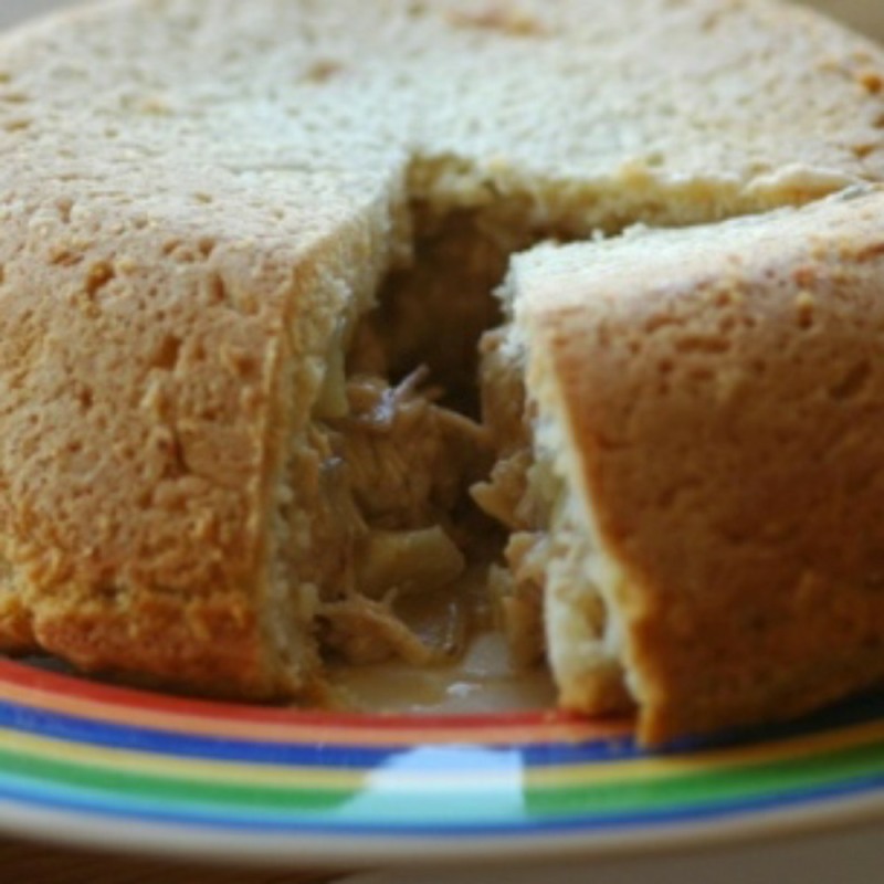 chicken and onion pie on a multi coloured rim plate