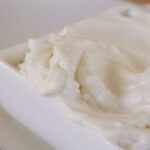 close up of mayonnaise in a small white dish.